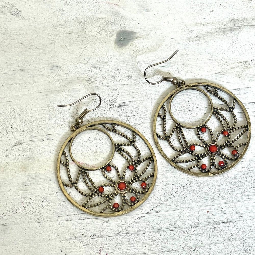 Brass tone circle earrings with floral pattern